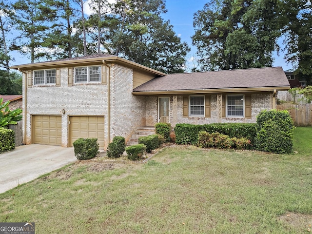 tri-level home featuring a garage and a front yard