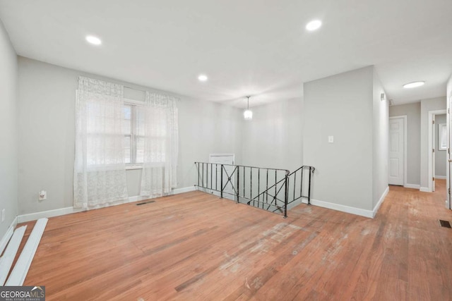 unfurnished room with hardwood / wood-style flooring