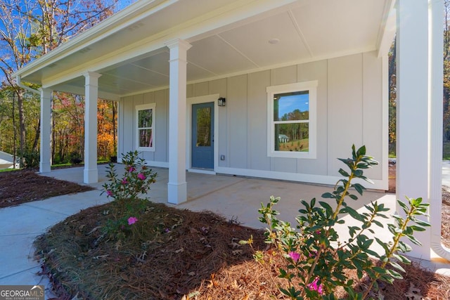 view of exterior entry with covered porch