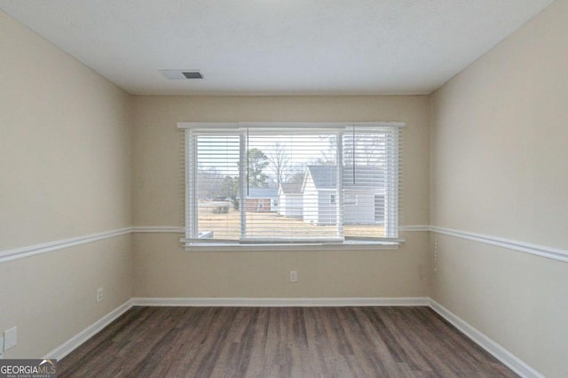 unfurnished room featuring dark hardwood / wood-style flooring