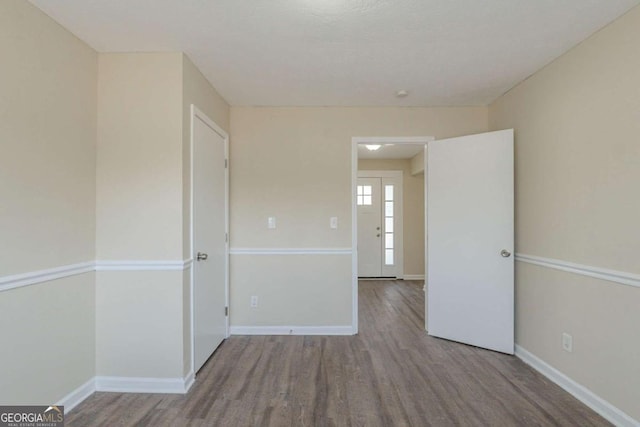 empty room with wood-type flooring