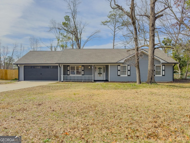 ranch-style house featuring a porch, a garage, and a front yard