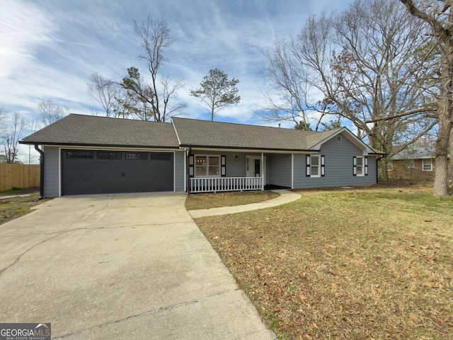 ranch-style house featuring a garage, a front yard, and covered porch