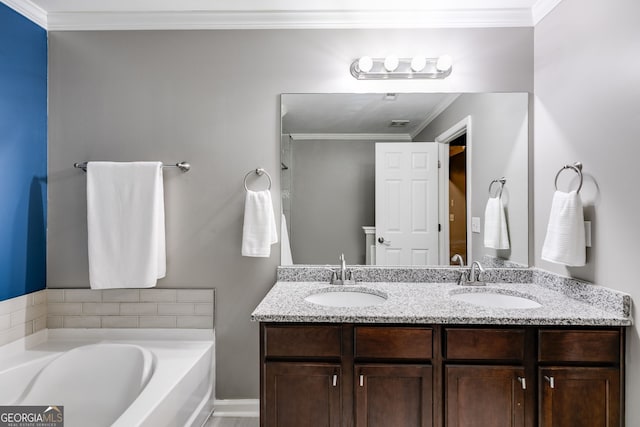 bathroom featuring vanity, crown molding, and a tub