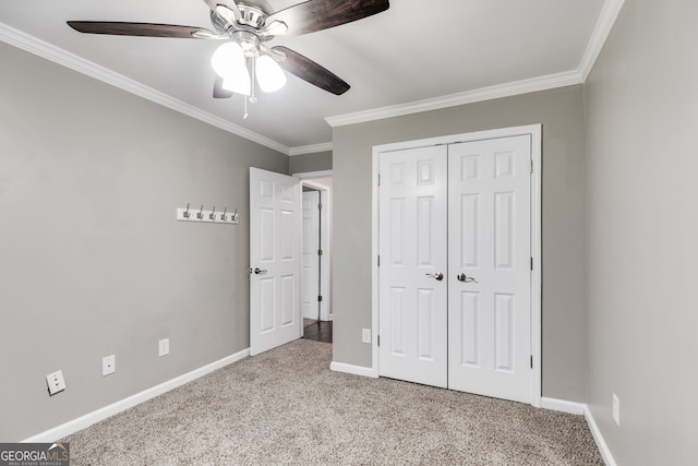 unfurnished bedroom with crown molding, light carpet, ceiling fan, and a closet