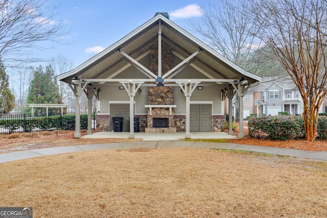 view of front of home featuring an outdoor stone fireplace