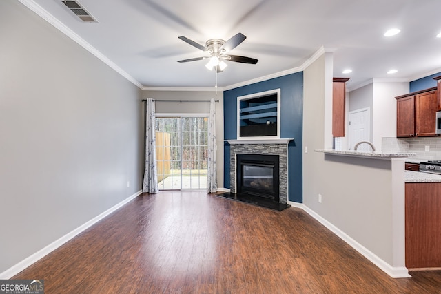 unfurnished living room with ornamental molding, dark hardwood / wood-style floors, and a fireplace