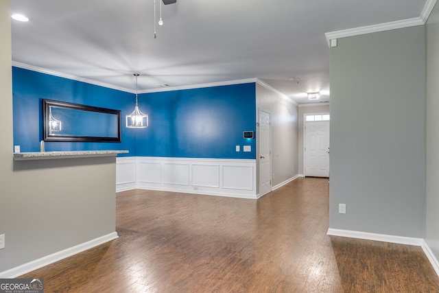 unfurnished room featuring ornamental molding and dark hardwood / wood-style flooring