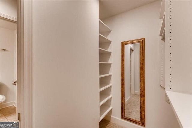 walk in closet with light tile patterned flooring