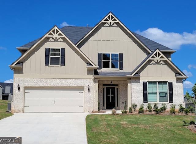 175 Osier Dr, Mcdonough, GA 30252 - craftsman house featuring concrete driveway, brick siding, a front lawn, and a garage
