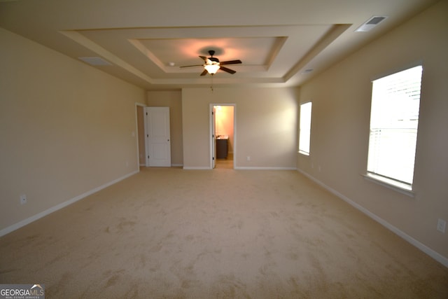 175 Osier Dr, Mcdonough, GA 30252 - empty room with a tray ceiling, a ceiling fan, light colored carpet, and baseboards