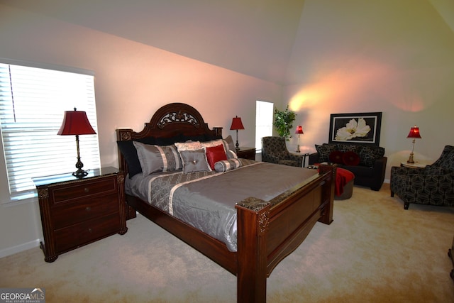 bedroom with light carpet, lofted ceiling, and baseboards