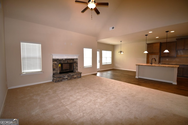 175 Osier Dr, Mcdonough, GA 30252 - unfurnished living room with dark colored carpet, baseboards, ceiling fan, high vaulted ceiling, and recessed lighting