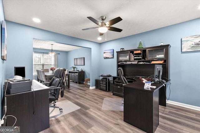 office with hardwood / wood-style flooring, a textured ceiling, and ceiling fan