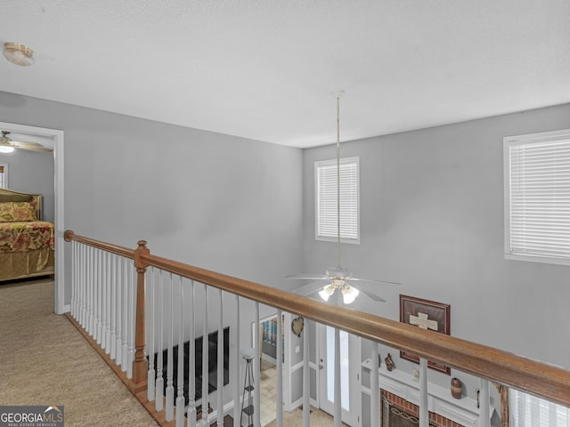 hallway with light colored carpet