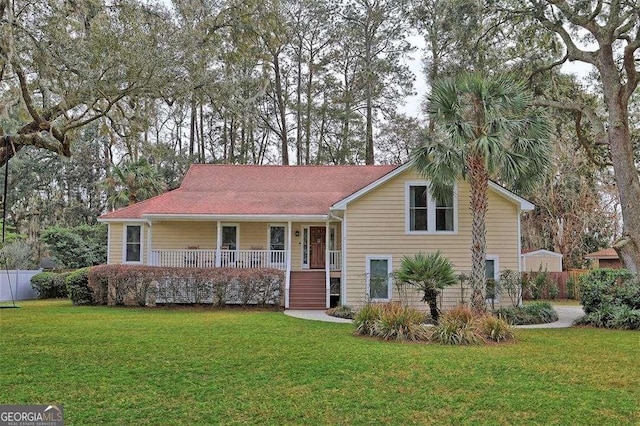 view of front facade with a front yard and covered porch