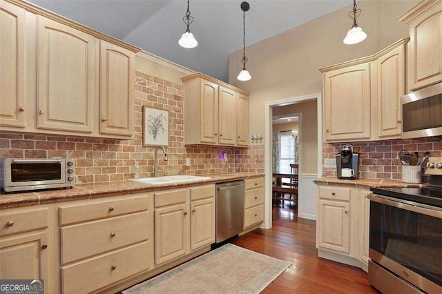 217 E Point Dr, Savannah, GA 31410 - kitchen featuring appliances with stainless steel finishes, light brown cabinets, light countertops, dark wood-style floors, and backsplash