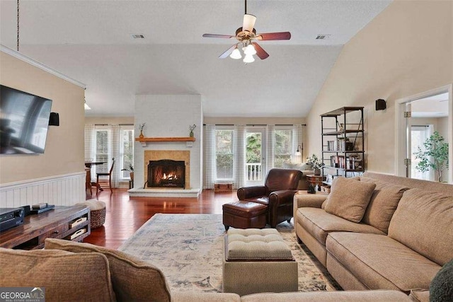 217 E Point Dr, Savannah, GA 31410 - living area featuring wood finished floors, ceiling fan, a warm lit fireplace, and high vaulted ceiling
