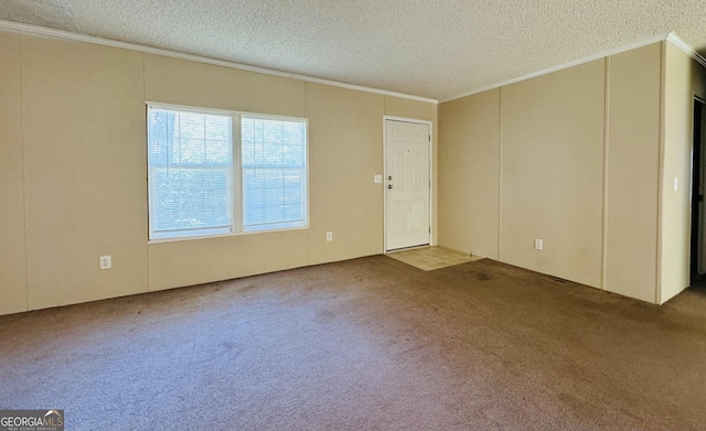 carpeted spare room featuring ornamental molding and a textured ceiling