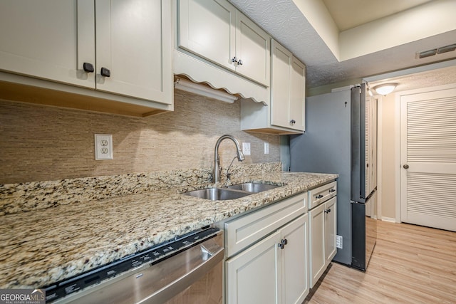 3205 Canyon Point Cir, Roswell, GA 30076 - kitchen featuring dishwasher, decorative backsplash, light wood-type flooring, and light stone counters