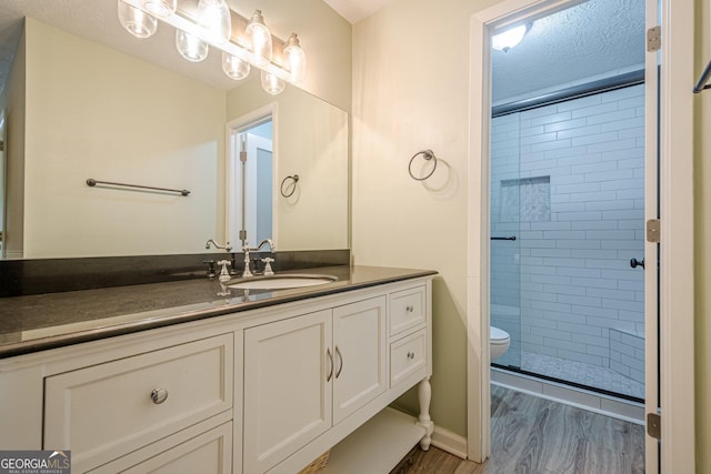3205 Canyon Point Cir, Roswell, GA 30076 - full bath featuring vanity, a shower stall, wood finished floors, and a textured ceiling