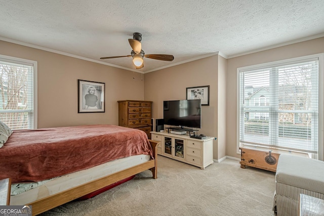 carpeted bedroom featuring ornamental molding, ceiling fan, and a textured ceiling