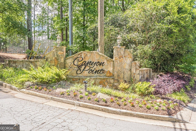 3205 Canyon Point Cir, Roswell, GA 30076 - kitchen with dishwasher, light stone counters, a sink, decorative backsplash, and wood finished floors