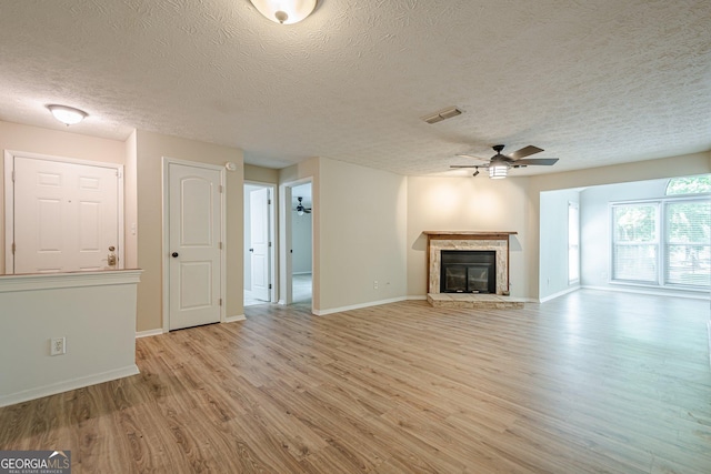3205 Canyon Point Cir, Roswell, GA 30076 - living area with wood finished floors, a ceiling fan, a textured ceiling, visible vents, and a stone fireplace