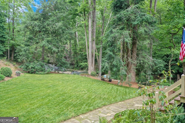 view of yard with a view of trees