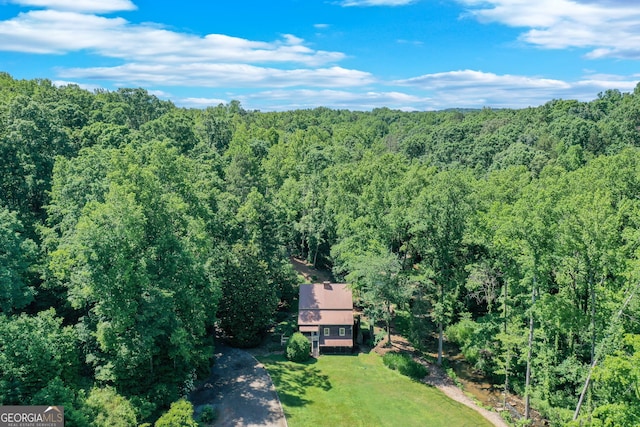 drone / aerial view featuring a forest view