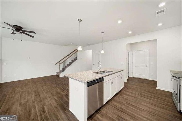 kitchen with decorative light fixtures, sink, white cabinets, stainless steel appliances, and a center island with sink