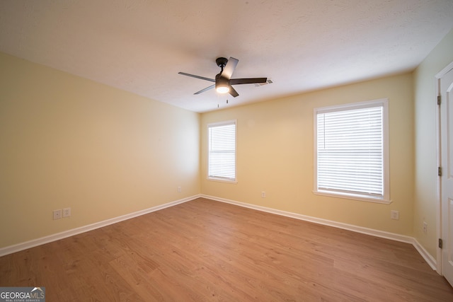 unfurnished room featuring ceiling fan and light wood-type flooring