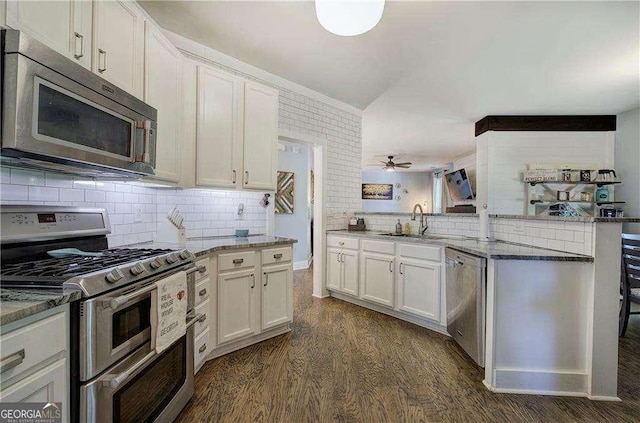 kitchen with white cabinetry, stainless steel appliances, and kitchen peninsula