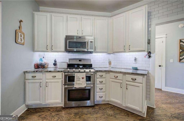 kitchen with stainless steel appliances, white cabinets, and stone counters