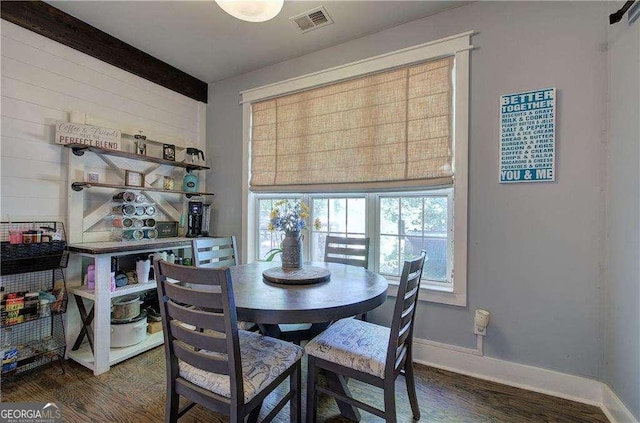 dining space with dark hardwood / wood-style flooring