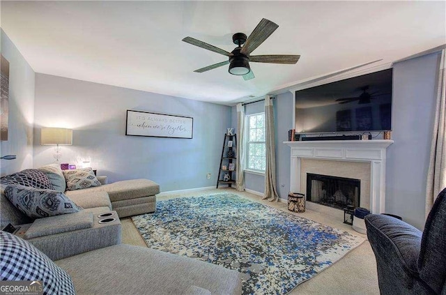 living room with ceiling fan and carpet