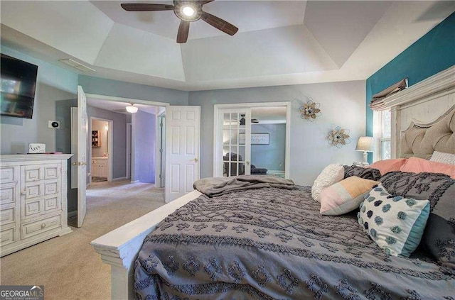 carpeted bedroom with a raised ceiling