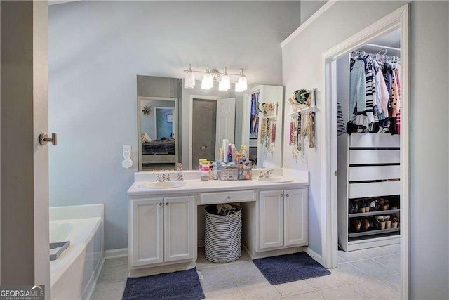 bathroom featuring vanity, tile patterned floors, and a bathing tub