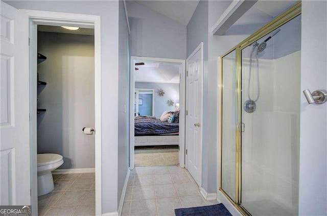 bathroom with walk in shower, toilet, and tile patterned flooring