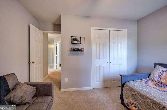 bedroom featuring a closet and light carpet