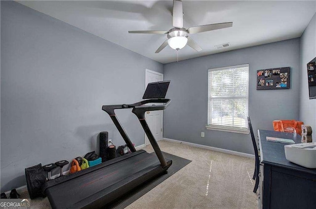 exercise room with light carpet and ceiling fan