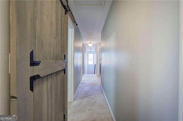 hallway with light colored carpet