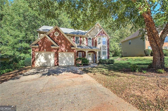 view of front of house featuring a garage and a front lawn