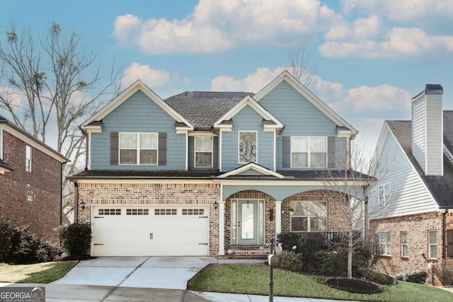 view of front of home featuring a garage and a front yard