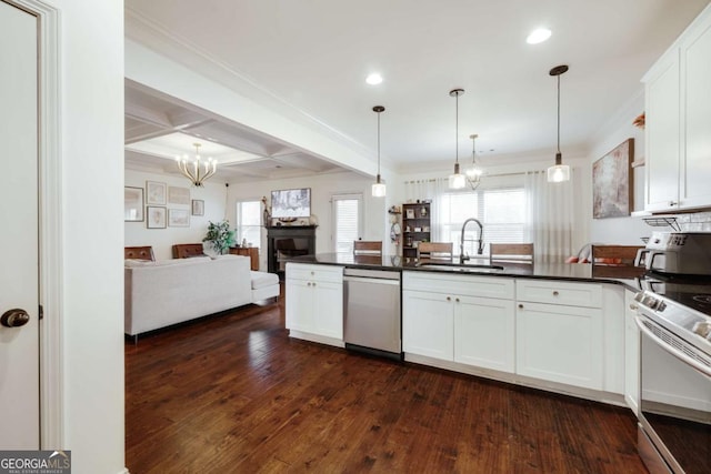 kitchen featuring appliances with stainless steel finishes, sink, and white cabinets