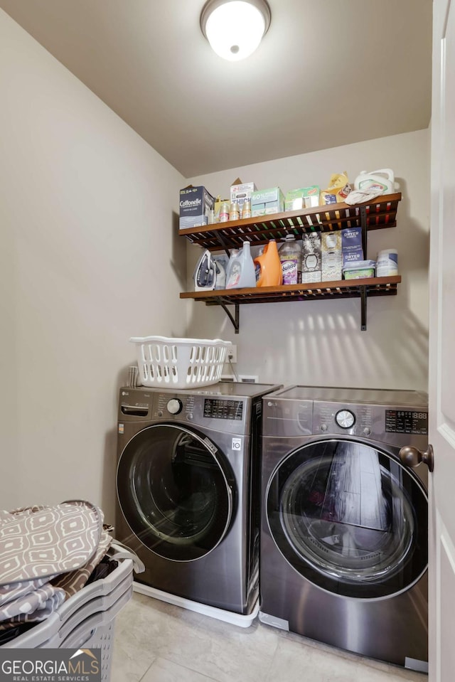 clothes washing area featuring washer and dryer