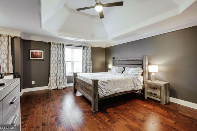 bedroom with dark wood-type flooring, ceiling fan, crown molding, and a raised ceiling