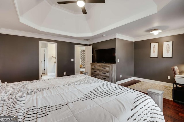 bedroom with ceiling fan, ornamental molding, dark hardwood / wood-style floors, and a raised ceiling