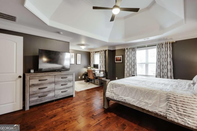 bedroom featuring crown molding, ceiling fan, dark hardwood / wood-style flooring, and a raised ceiling