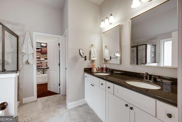 bathroom featuring tile patterned floors, vanity, and a shower with door